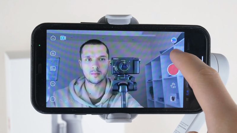 On the right side of the screen, we can see the shooting modes, such as photo, video, panorama, slow motion, dolly zoom, time lapse, and hyper lapse. Then, you can use the smart templates for your videos. If you are a beginner cameraman and don't know how to edit the videos, these templates may be very helpful. The next icon is to switch between front and rear cameras. There is also a shutter button, gesture control button, and gallery icon on the right. On the left side, you can return to the home page, switch between automatic and manual mode, change video settings, use glamour effects, and go to the settings menu. In a gimbal settings menu, you can select walk or run mode, change follow mode, joystick speed, zoom speed, invert pan control, invert tilt control, and gimbal auto calibration. In a shoot menu, you can turn on/off flashlight, select a built-in, external or Bluetooth microphone, enable grid, change white balance, gesture control, smart shooting and HDR shooting.