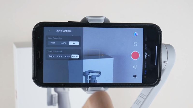 On the right side of the screen, we can see the shooting modes, such as photo, video, panorama, slow motion, dolly zoom, time lapse, and hyper lapse. Then, you can use the smart templates for your videos. If you are a beginner cameraman and don't know how to edit the videos, these templates may be very helpful. The next icon is to switch between front and rear cameras. There is also a shutter button, gesture control button, and gallery icon on the right. On the left side, you can return to the home page, switch between automatic and manual mode, change video settings, use glamour effects, and go to the settings menu. In a gimbal settings menu, you can select walk or run mode, change follow mode, joystick speed, zoom speed, invert pan control, invert tilt control, and gimbal auto calibration. In a shoot menu, you can turn on/off flashlight, select a built-in, external or Bluetooth microphone, enable grid, change white balance, gesture control, smart shooting and HDR shooting.